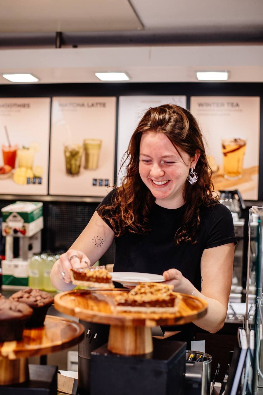 Staff member behind the counter with treats