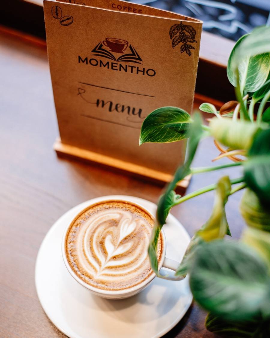 Cappuccino on the table with the menu stand