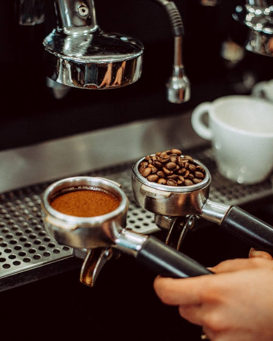 Portafilters with ground coffee and whole beans